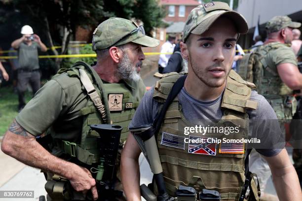 White nationalists, neo-Nazis and members of the "alt-right" with body armor and combat weapons evacuate comrades who were pepper sprayed after the...