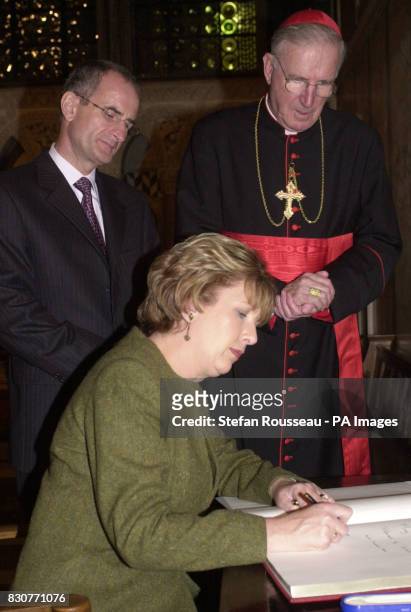 Irish President Mary McAleese, with the Archbishop of Westminster Cardinal Cormac Murphy-O'Conor and her husband Dr Martin McAleese, signs the...