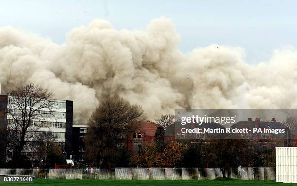 The area smothered in a plume of dust and smoke, where St John's House, the former Inland Revenue, 19-storey tower block in Bootle, Merseyside, had...