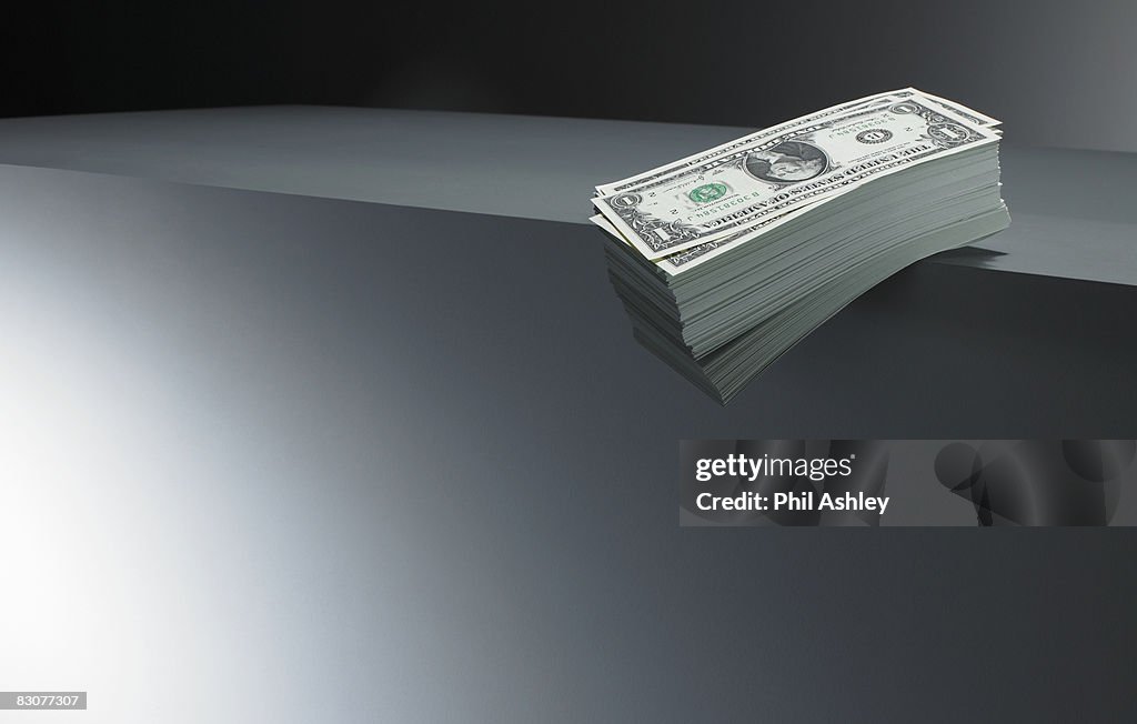 Pile of dollar bills on an edge