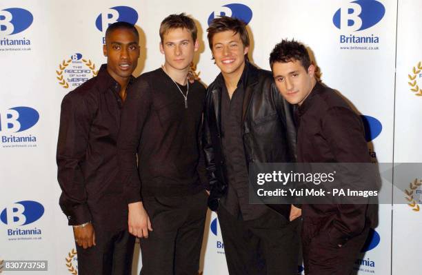 Simon Webbe and the members of Blue posing for the media