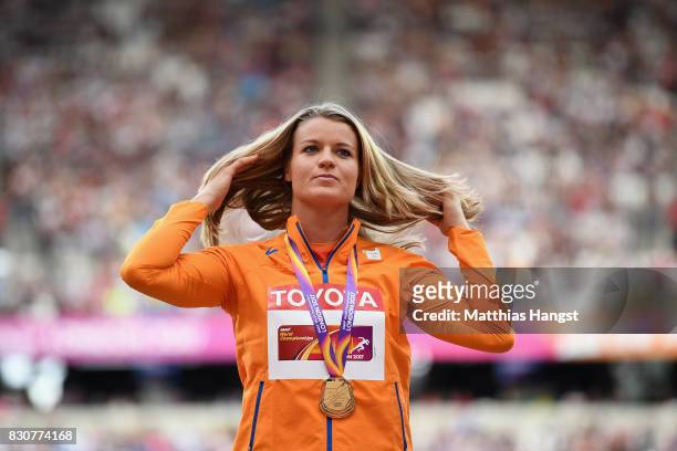 Dafne Schippers of the Netherlands, gold, poses with her medals for the Women's 200 metres during day nine of the 16th IAAF World Athletics...