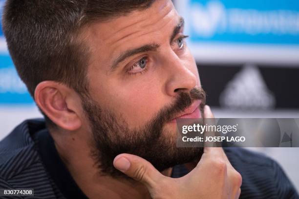 Barcelona's defender Gerard Pique looks on during a press conference before a training session at the sports Center FC Barcelona Joan Gamper in Sant...