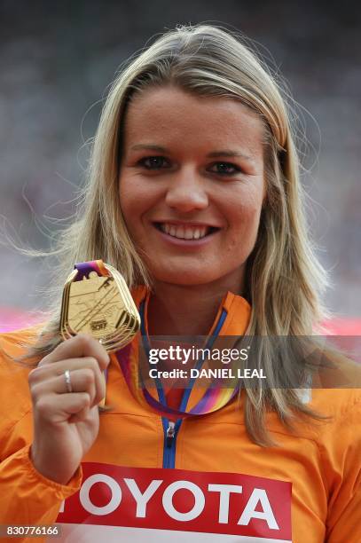 Gold medallist Netherlands' Dafne Schippers poses on the podium during the victory ceremony for the women's 200m athletics event at the 2017 IAAF...