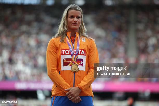 Gold medallist Netherlands' Dafne Schippers poses on the podium during the victory ceremony for the women's 200m athletics event at the 2017 IAAF...