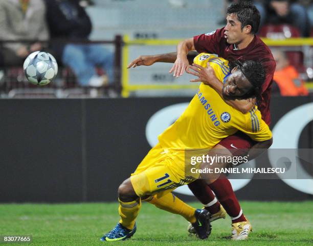 Chelsea's Ivorian Didier Drogba vies for the ball with CFR Cluj's De Sousa during their UEFA Champions League football matchon October 1, 2008 in...