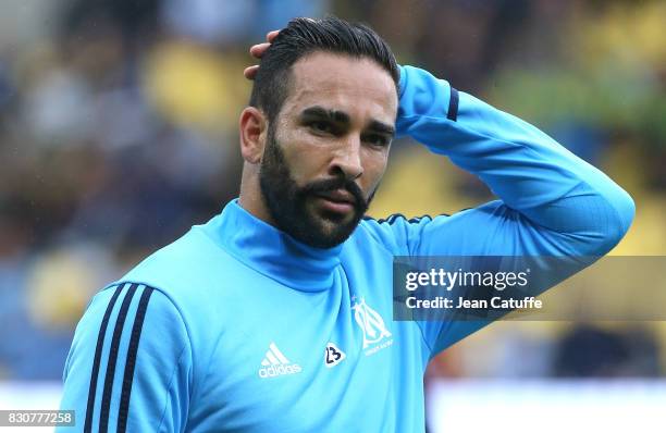 Adil Rami of OM warms up during the French Ligue 1 match between FC Nantes and Olympique de Marseille at Stade de la Beaujoire on August 12, 2017 in...