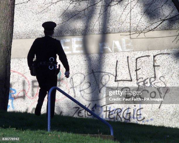 Police officers search the area of the shooting in the Forthriver road area of North Belfast, where former police agent William Stobie, an ex-Ulster...