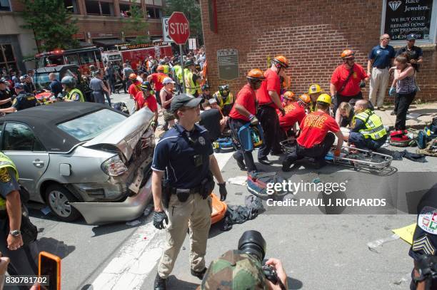 Woman is received first-aid after a car accident ran into a crowd of protesters in Charlottesville, VA on August 12, 2017. A picturesque Virginia...