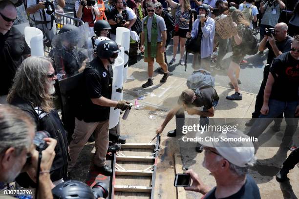 White nationalists, neo-Nazis and members of the "alt-right" clash with counter-protesters as they attempt to guard the entrance to Emancipation Park...