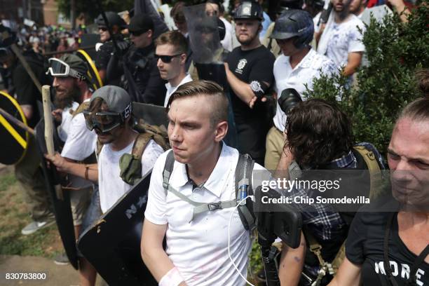 White nationalists, neo-Nazis and members of the "alt-right" exchange insluts with counter-protesters as they attempt to guard the entrance to...