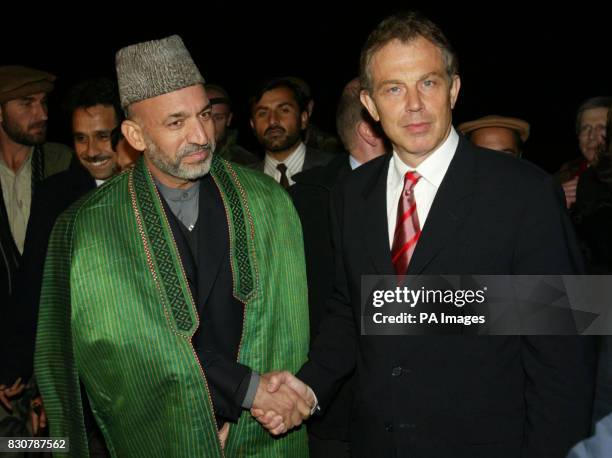 British Prime Minister Tony Blair meets Afghanistan's interim leader Hamid Karzai upon his arrival at Bagram air base. Blair flew into Afghanistan on...