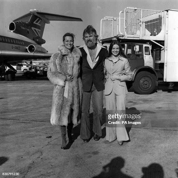 American singing star Kenny Rogers at London's Heathrow airport when he arrived with his two favourite ladies - his bride of a few weeks, television...