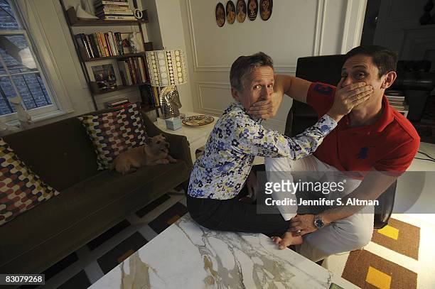 Designer Jonathan Adler and his partner Simon Doonan, creative director of Barneys New York, pose for a portrait session at their New York City home.