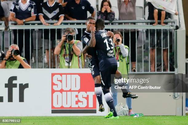 Bordeaux's Brazilian forward Malcom celebrates after scoring a goal with his teammate Bordeaux's Senegalese midfielder Younousse Sankhare during the...