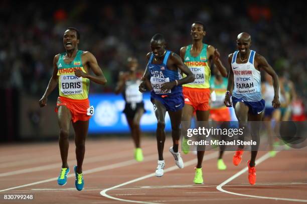 Muktar Edris of Ethiopia celebrates as he crosses the line to win ahead of Paul Kipkemoi Chelimo of the United States and Mohamed Farah of Great...