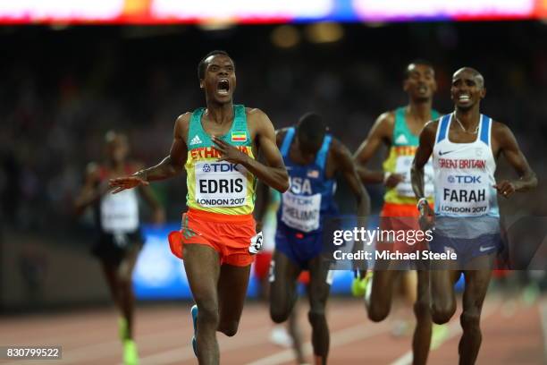 Muktar Edris of Ethiopia celebrates as he crosses the line to win ahead of Paul Kipkemoi Chelimo of the United States and Mohamed Farah of Great...