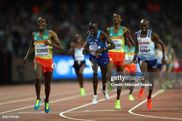 Muktar Edris of Ethiopia celebrates as he crosses the line to win ahead of Paul Kipkemoi Chelimo of the United States and Mohamed Farah of Great...