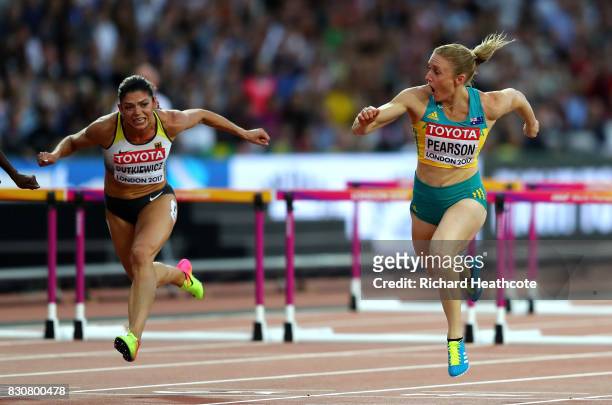 Sally Pearson of Australia leads Pamela Dutkiewicz of Germany to the finish line in the Women's 100 metres hurdles final during day nine of the 16th...