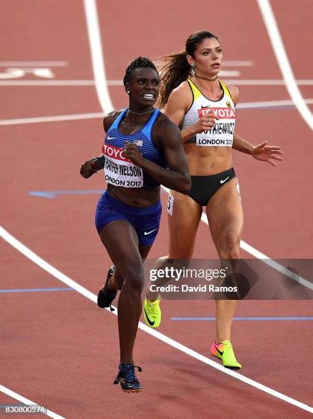 Dawn Harper Nelson of the United States and Pamela Dutkiewicz of Germany compete in the Women's 100 metres hurdles final during day nine of the 16th...