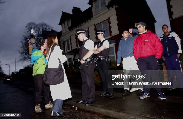 Police, media and local residents congregate at a house in Victoria Street, Tipton, West Midlands, believed to be the home of Shafiq Rasul and Asif...