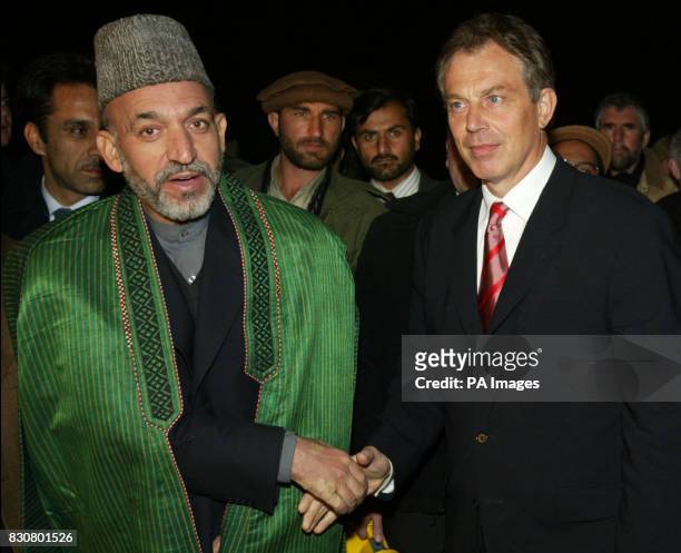 British Prime Minister Tony Blair meets Afghanistan's interim leader Hamid Karzai upon his arrival at Bagram air base. Afghanistan's interim leader...