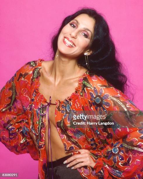 Singer and actress Cher poses for a photo session in a Bob Mackie blouse on March 21, 1977 in Los Angeles, California.