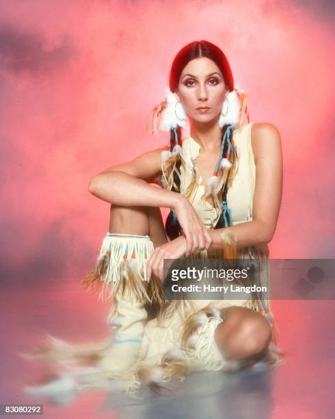 Singer and actress Cher poses for a photo session in a Bob Mackie blouse on March 21, 1977 in Los Angeles, California.