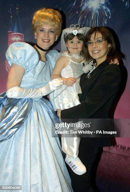 Cinderella poses with Kym Marsh and her daughter Emily as they arrive for the video premiere of Walt Disney's Cinderella II at the Empire Cinema in...