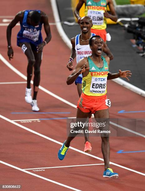 Muktar Edris of Ethiopia celebrates as he crosses the finishline ahead of Mohamed Farah of Great Britain, and Paul Kipkemoi Chelimo of the United...