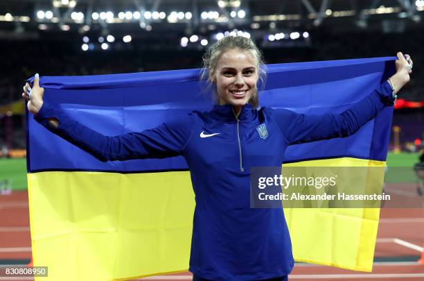 Yuliia Levchenko of Ukraine celebrates with a flag after winning silver in the Women's High Jump Final during day nine of the 16th IAAF World...