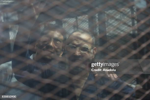 Egyptian Muslim Brotherhood Official Issam Al-'Aryan gestures behind the cage during the trial session known as breaking up the Rabaa el-Adaweya...