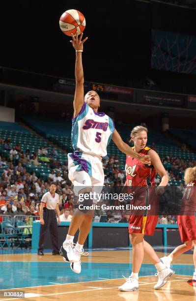 Dawn Staley#5 of the Charlotte Sting goes to the basket against Debbie Black#31 of the Miami Sol on June 22, 2002 at the Charlotte Coliseum in...