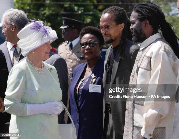 Britain's Queen Elizabeth II meets Rastafarians Ziggy Soul and Lloyd 'Juba' Johnson, at the Hugh Sherlock School Trenchtown, Jamaica, during her...