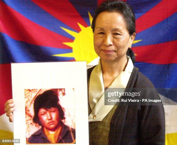 Representive of the Dalai Lama Kesang Y Takla and with Maruta from the Milton Keynes Peace Pagoda, holds a picture of nun Ngawang Sangdrol after...