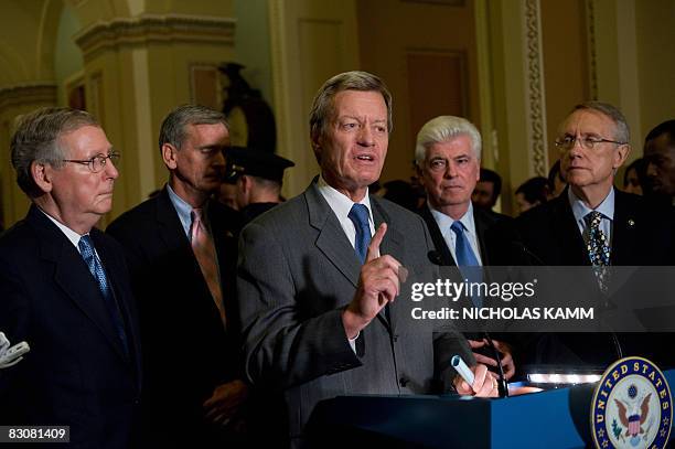 Democratic Senator Max Baucus of Montana speaks to the press with Senate Banking Committee Chairman Chris Dodd , Senate Majority Leader Harry Reid ,...