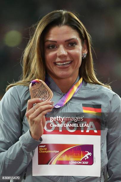 Bronze medallist Germany's Pamela Dutkiewicz poses on the podium during the victory ceremony for the women's 100m hurdles athletics event at the 2017...