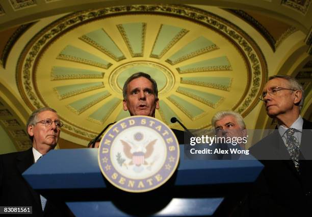 Sen. Judd Gregg speaks as Senate Minority Leader Mitch McConnell Sen. Christopher Dodd , and Senate Majority Leader Harry Reid listen at a news...