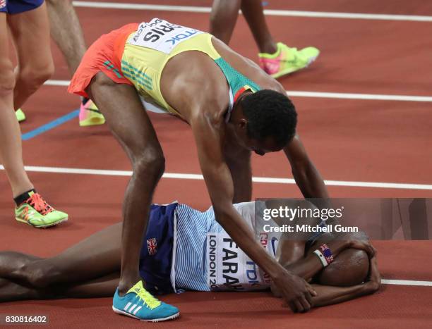 Muktar Edris of Ethiopia consoles Mohamed Farah of Great Britain and Northern Ireland during day nine of the 16th IAAF World Athletics Championships...