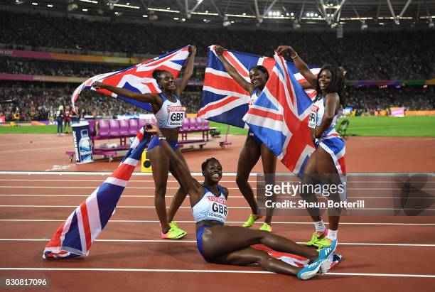 Asha Philip, Deriree Henry, Dina Asher-Smith and Daryll Neita of Great Britain celebrate winning silver in the Women's 4x100 Metres Final during day...