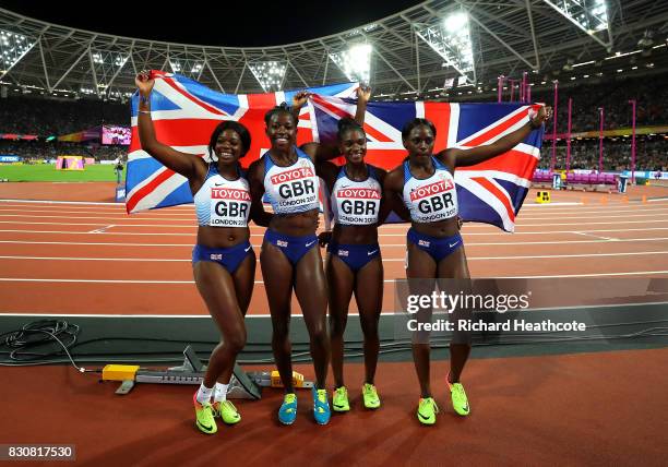 Asha Philip, Deriree Henry, Dina Asher-Smith and Daryll Neita of Great Britain celebrate winning silver in the Women's 4x100 Metres Final during day...