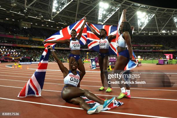 Asha Philip, Deriree Henry, Dina Asher-Smith and Daryll Neita of Great Britain celebrate winning silver in the Women's 4x100 Metres Final during day...