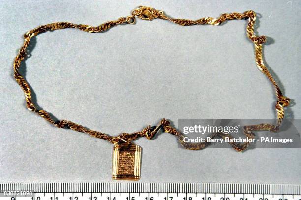 Gold pendant displaying Arabic writing, found around the neck of a body found on Exmoor, Somerset, is released during a press conference at Taunton...