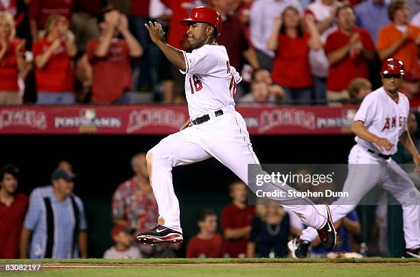 Garret Anderson of the Los Angeles Angels of Anaheim runs in to home plate after an RBI single hit by teammate Torii Hunter during the third inning...