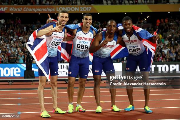 Chijindu Ujah, Adam Gemili, Daniel Talbot and Nethaneel Mitchell-Blake of Great Britain celebrate winning gold in the Men's 4x100 Relay final during...