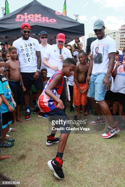 Carmelo Anthony, Danilo Beauchamp and Jimmy Butler participate with kids of Worldwide Day of Play at Bahia Urbana Bay Side Park on August 12, 2017 in...