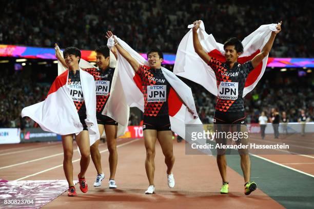 Shuhei Tada, Shota Iizuka, Yoshihide Kiryu and Kenji Fujimitsu of Japan celebrate winning bronze in the Men's 4x100 Relay final during day nine of...