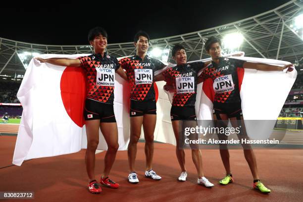 Shuhei Tada, Shota Iizuka, Yoshihide Kiryu and Kenji Fujimitsu of Japan celebrate winning bronze in the Men's 4x100 Relay final during day nine of...