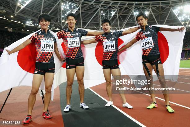 Shuhei Tada, Shota Iizuka, Yoshihide Kiryu and Kenji Fujimitsu of Japan celebrate winning bronze in the Men's 4x100 Relay final during day nine of...