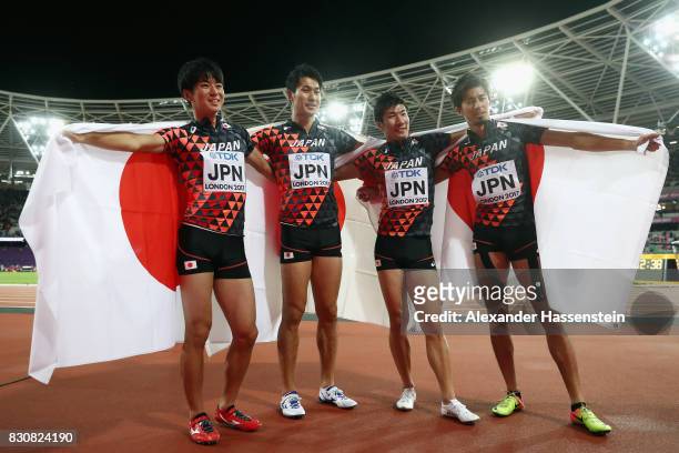 Shuhei Tada, Shota Iizuka, Yoshihide Kiryu and Kenji Fujimitsu of Japan celebrate winning bronze in the Men's 4x100 Relay final during day nine of...